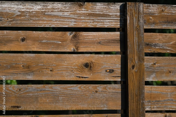 Fototapeta Rustic wooden fence panels in an outdoor background with weathered planks