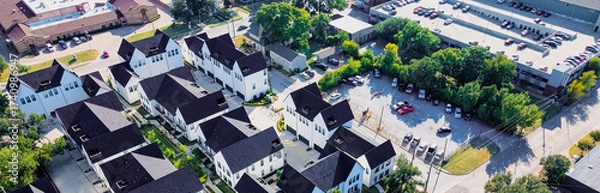 Fototapeta Panorama aerial view townhomes near Cooper Street, Arlington, Texas with rooftop ramp garage, commercial buildings reinforce accessibility and urban layering near university and retail zones