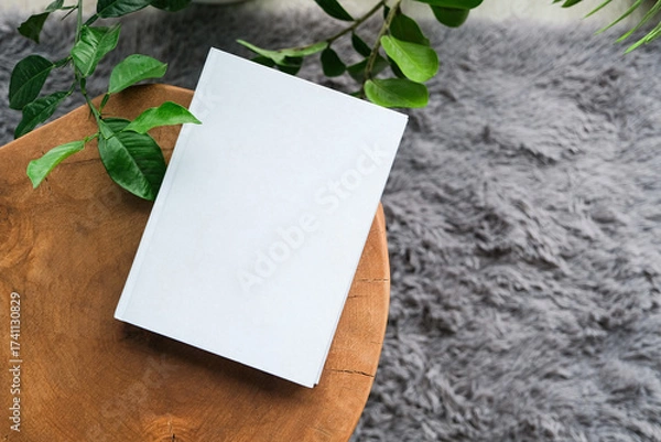 Fototapeta blank book mockup on decorative table with many green plants