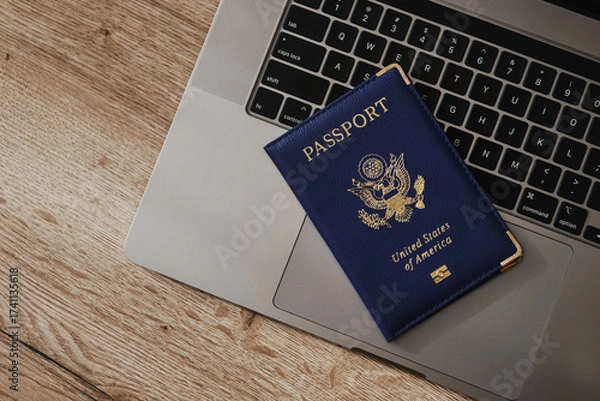 Fototapeta United States passport on laptop keyboard, symbolizing modern travel, digital identity verification, and international documentation