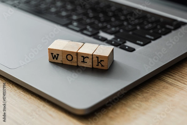 Fototapeta Wooden blocks spelling WORK on laptop keyboard
