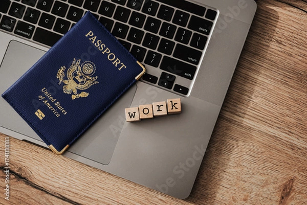 Fototapeta US passport and wooden blocks spelling work on laptop, concept of work visa, remote job, or digital nomad travel authorization