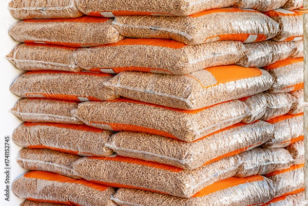Fototapeta Wood pellets in bags, neatly stacked, presenting a renewable biomass energy source for heating
