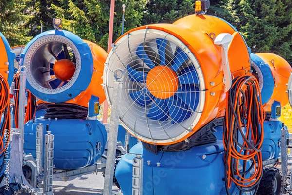 Fototapeta Snow cannons standing ready for winter ski season. Equipment for creating artificial snow