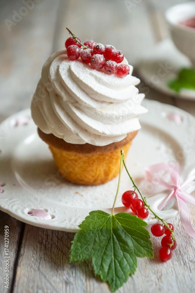 Fototapeta Red currant cake and a cup of aromatic tea in a porcelain cup on the table.
