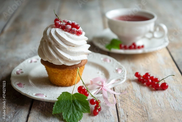 Fototapeta Red currant cake and a cup of aromatic tea in a porcelain cup on the table.