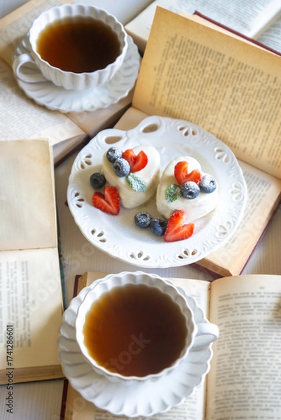 Fototapeta Red currant cake and a cup of aromatic tea in a porcelain cup on the table.