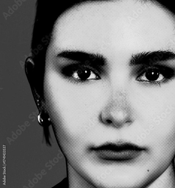 Fototapeta Face of a beautiful young woman in closeup in black and white monochrome with halftone effect