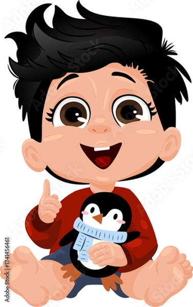 Fototapeta A cheerful young boy with short black hair sits on the floor. He wears a red sweater and holds a penguin toy. The boy smiles and gives a thumbs up.