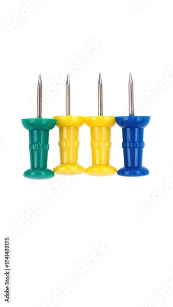 Fototapeta Three colored push pins,  vertical arrangement,  isolated on black background