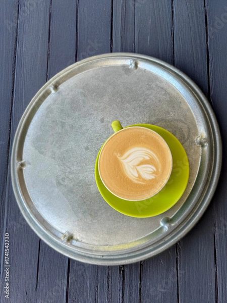 Fototapeta Perfect Latte Art in a Lime Green Cup on a Silver Tray and Dark Wood Background. Copyspace