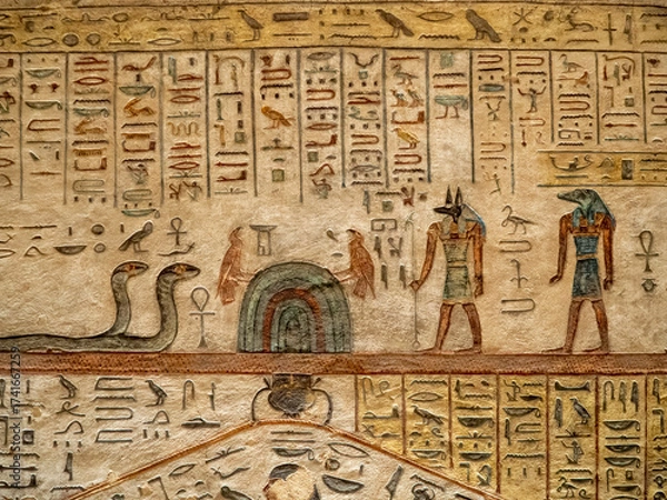 Fototapeta VALLEY OF THE KINGS, EGYPT : Interior of a tomb in the Valley of the Kings, featuring intricate wall paintings and hieroglyphs that tell stories of ancient Egyptian pharaohs.