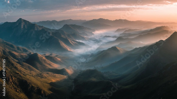 Obraz sunrise over mountain peaks, mist rolling through valleys