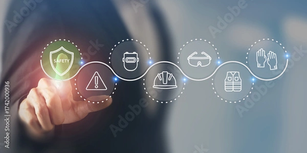 Fototapeta Workplace Safety Concept. Virtual interface displaying safety related icons; a shield, warning sign, hard hat, goggles, gloves and vest. Enhancing workplace safety, hazard prevention, PPE management.