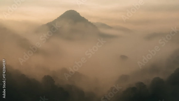 Fototapeta A mesmerizing view of a misty mountain landscape, a sense of serenity and mystery. Capture the tranquility of nature.