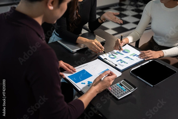 Fototapeta Business team working and studying together with tablet document graph paper in office, discuss finance and marketing solution reporting file in working place.