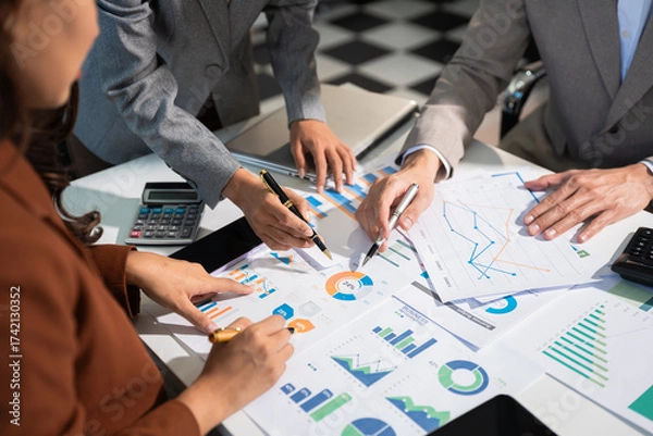 Fototapeta Business corporate team brainstorming, planning strategy having a discussion Analysis investment researching with chart at office desk documents in office.