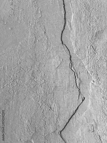 Fototapeta Close-up of an old concrete or plastered wall with a deep vertical crack and a rough, coarse texture.