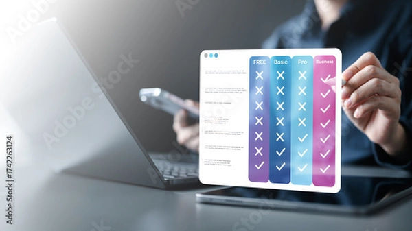 Fototapeta pricing, table, compare, plans, monthly, annual, tiers, Hand using tablet with digital pricing table interface comparing plans, tiers, features, and subscription options for online business services.