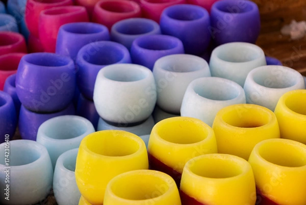 Fototapeta handmade candles of different colors in a traditional market
