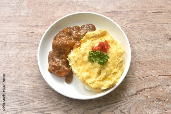 Obraz fried creamy egg omelet topping plain rice dressing potato and carrot in Japanese curry on plate 