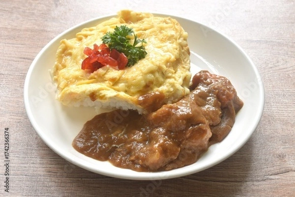 Obraz fried creamy egg omelet topping plain rice dressing potato and carrot in Japanese curry on plate 