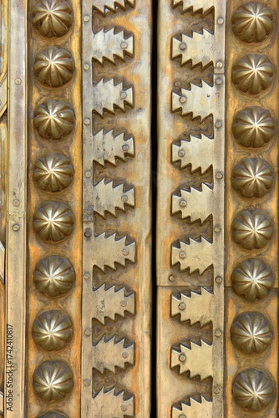 Fototapeta Brass doors adorned with Moroccan patterns, metal filigree, and intricate relief work. Royal Palace, Fez, Morocco