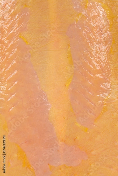 Fototapeta A close-up detail captures the texture and color of raw chicken breast skin, showing subtle variations in tone