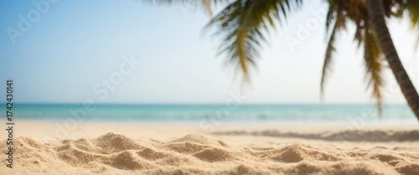 Fototapeta Sand with blurred Palm and tropical beach bokeh background Summer vacation and travel concept
