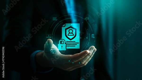 Fototapeta Data protection and cybersecurity concept with businessman holding hologram icon of secure personal information, digital privacy policy, and confidential identity management
