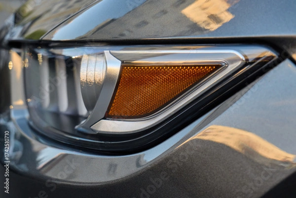 Fototapeta Close up of modern car headlight detail in sunlight