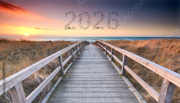 Fototapeta flying birds in shape of 2026 the new year flying over wooden bridge to the sea 