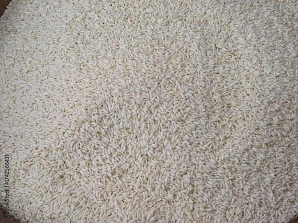 Fototapeta Close-up, high-angle shot of densely packed white sticky rice grains, with a uniform milky-white texture under bright, even lighting.