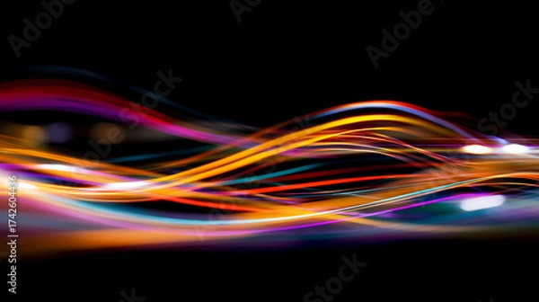 Fototapeta Abstract light trails with vibrant colors on a dark black background
