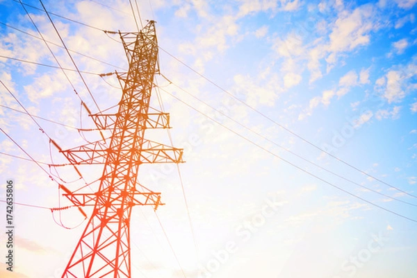 Fototapeta Sunset View of a Tall Power Tower With Wires on Colorful Sky at Dusk in Open Field. Power tower on dusk sky filled with clouds. Electric tower. Transmission Lines Tower Erection. High voltage.