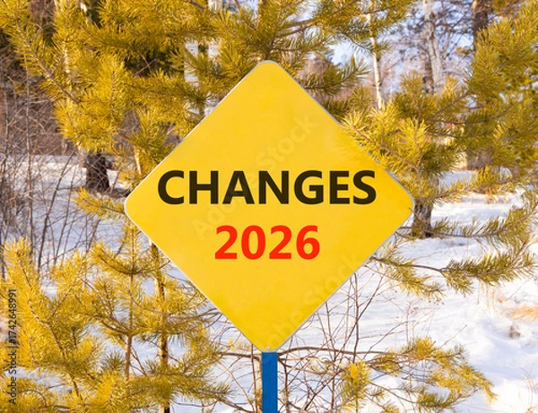 Fototapeta Changes 2026 symbol. Concept words Changes 2026 on beautiful yellow road sign. Beautiful winter forest background. Business and changes 2026 concept. Copy space.