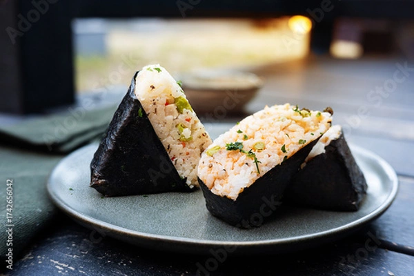 Fototapeta Japanese onigiri rice ball with nori seaweed on black background .