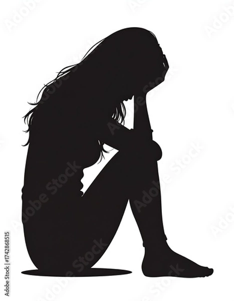 Fototapeta Silhouette of a despondent person, head in hands, in a seated posture
