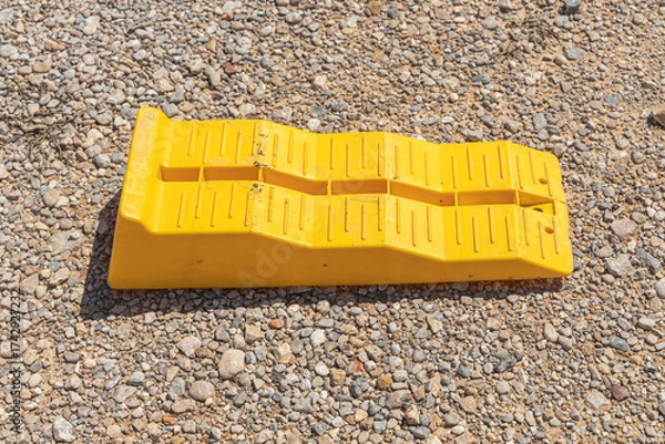 Obraz Yellow leveling block on the brown soil
