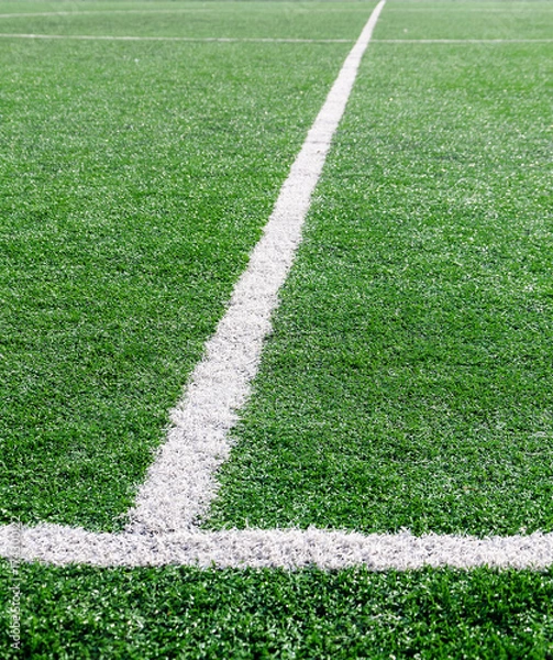 Fototapeta White stripe on the green soccer field from top view