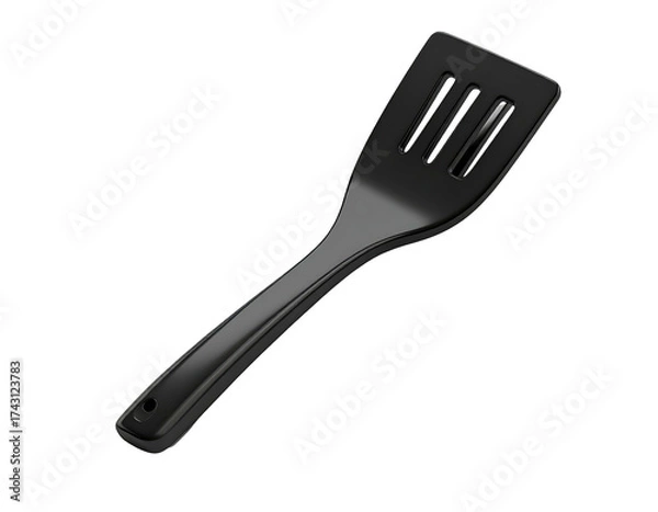 Fototapeta A shiny, black kitchen utensil with slots, angled against a black background
