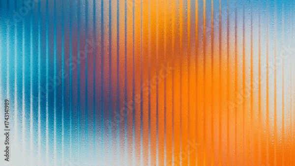 Fototapeta Abstract blurred background with vertical ribbed glass effect in vibrant blue orange and purple hues