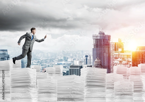 Fototapeta Precise businessman in suit running with phone.