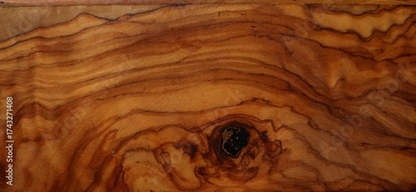 Fototapeta Wood texture background. Different shades of brown, ocher, orange, black. Natural curved lines and waves are unevenly arranged. Black spot at the bottom of the background. Floor, furniture, interior.