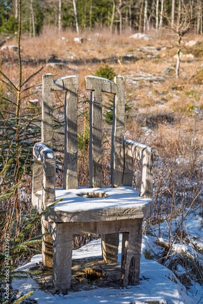 Fototapeta Chair carved from a tree stump in a forest