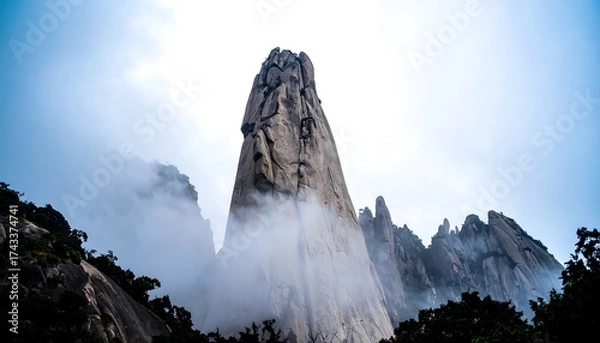 Obraz Towering Granite Peak Emerging from Mist in Huangshan Mountains.