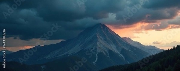 Fototapeta Dramatic Storm Clouds Gathering Over Mountain Peak, Casting Long Shadows Across the Landscape