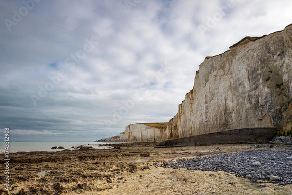 Fototapeta The pebble beach of Bois de Cise in Ault, with the Cliffs and the village in background, alabaster coast, department of Seine Maritime, Normandie region, France.