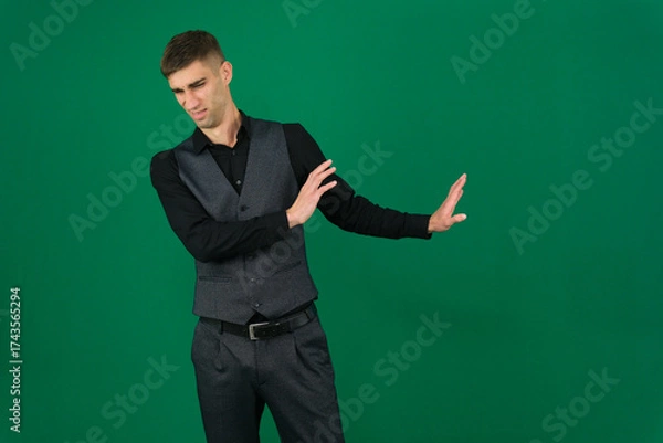 Fototapeta Professional collection of attractive European man in elegant business suit vest and black shirt green chroma key background expressing various emotions gestures and confident movements ideal for ad