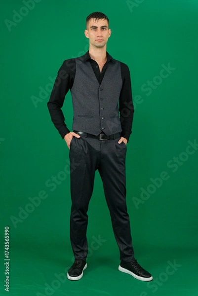 Fototapeta Professional collection of attractive European man in elegant business suit vest and black shirt green chroma key background expressing various emotions gestures and confident movements ideal for ad